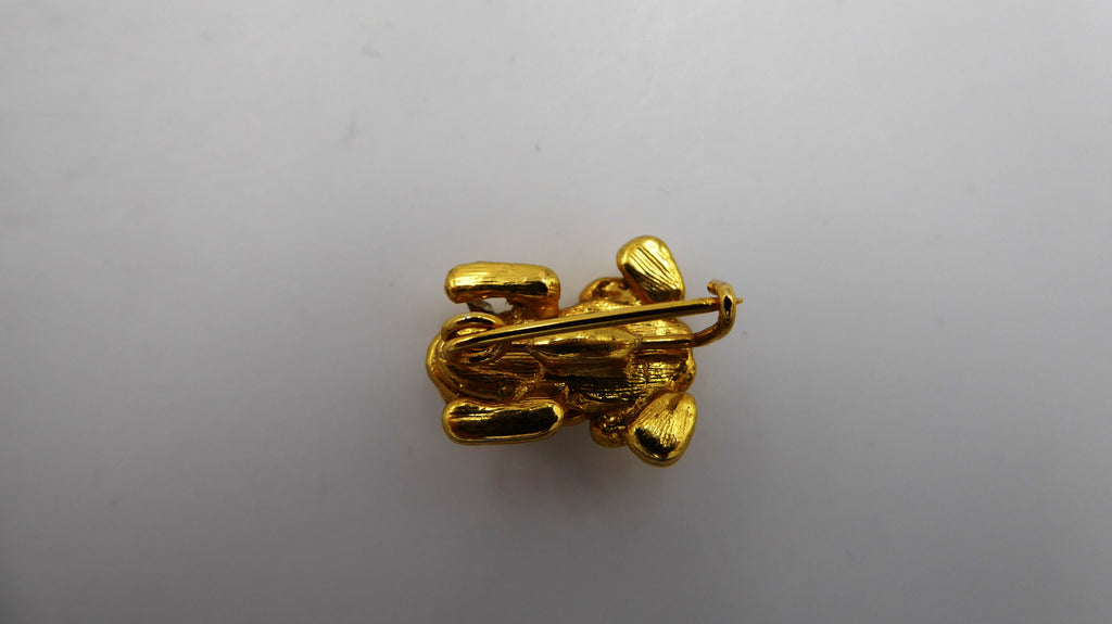 Belle petite broche en métal doré et strass