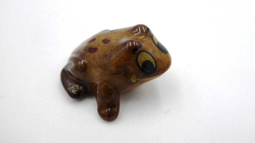 Petite grenouille en céramique marron à pois noirs