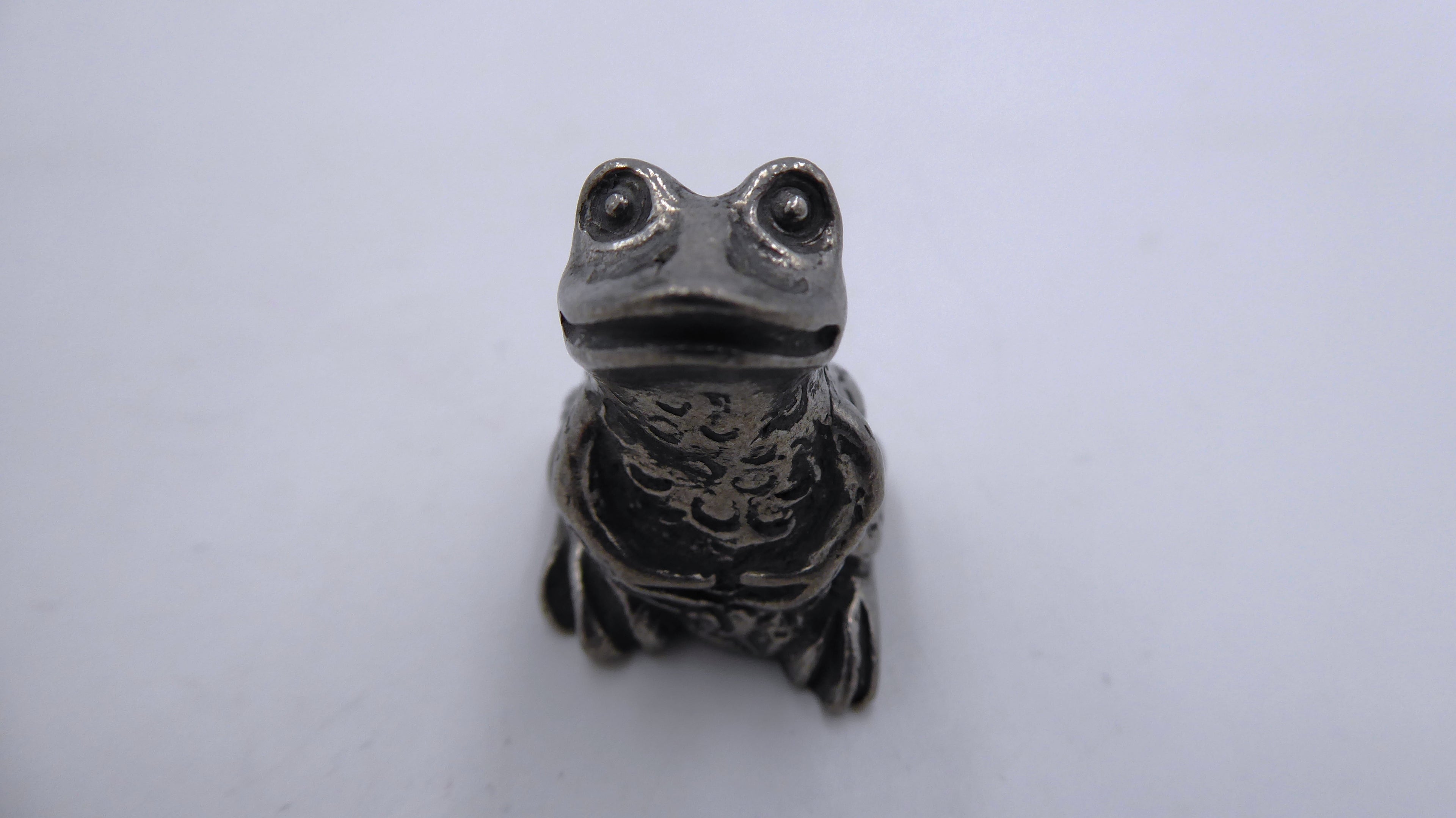 Grenouille en étain pattes sur le ventre