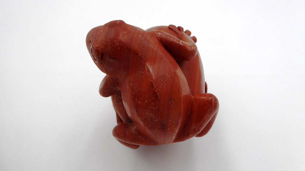 Rare grenouille en jaspe rouge de bonne taille posée sur une tête de mort