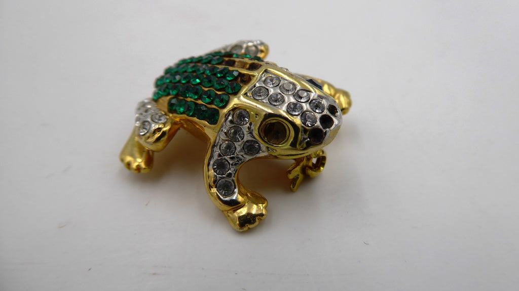 Belle petite broche en métal doré et strass