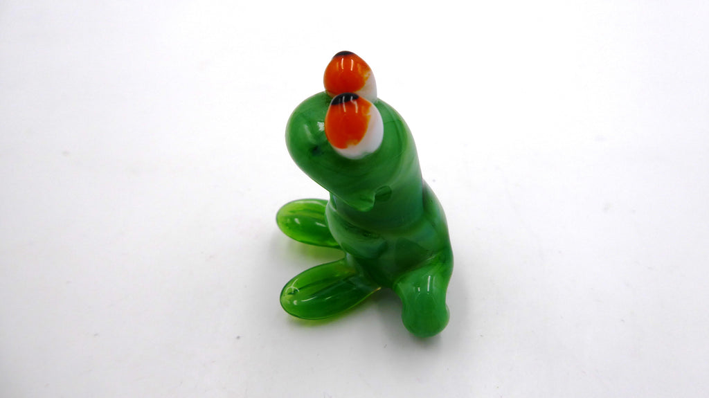 Petite grenouille en verre soufflé aux yeux orangés