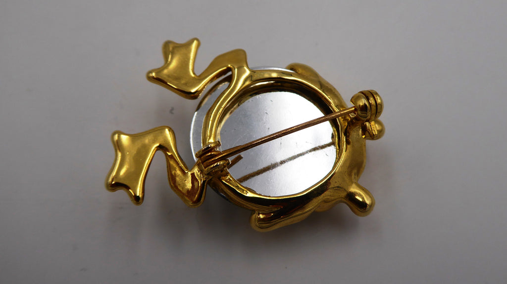 Broche grenouille en métal doré incrusté d'une pierre à facette